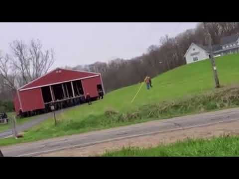 Amish people move a building by hand