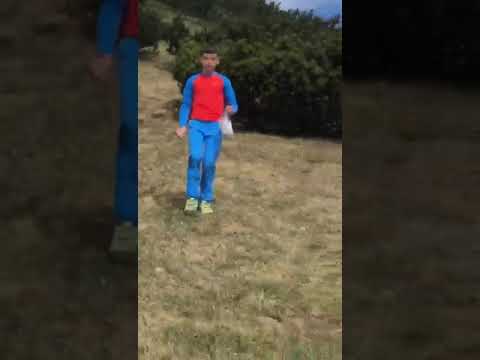 A child closely followed by a threatening bear